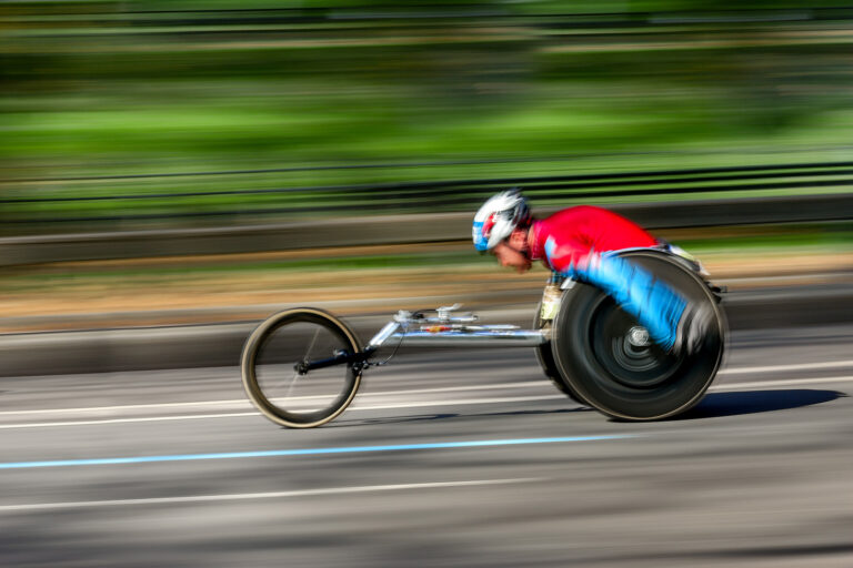 wheelchaor racer with blurred background moving at high speed